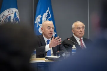 Secretary Mayorkas delivers remarks during the public session of the Council meeting, with Co-Chair William Bratton to his left