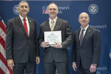 FLETC Director Benjamine Huffman (left), Innovation Award recipient Rock R. Smith (center), with DHS Secretary Alejandro Mayorkas (right).