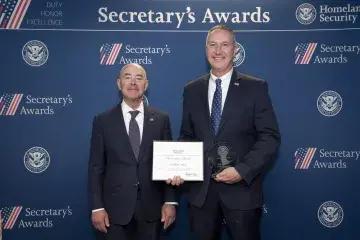 DHS Secretary Alejandro Mayorkas (left) with Innovation Award recipient William Csontos (right).