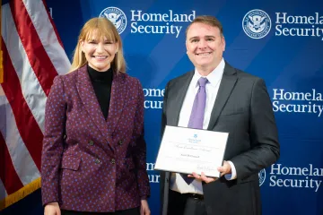 Acting DHS Deputy Secretary Kristie Canegallo with Team Excellence Award recipient, Scott McConnell.