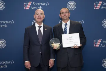 DHS Secretary Alejandro Mayorkas (left) with Innovation Award recipient Dave Cote (right).