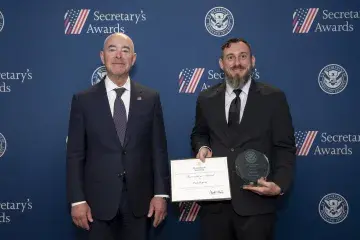 DHS Secretary Alejandro Mayorkas (left) with Innovation Award recipient Paul Harvey (right).