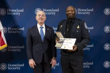 DHS Secretary Alejandro Mayorkas with Secretary's Gold Medal recipient, Barquette Kane.