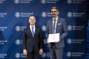 DHS Secretary Alejandro Mayorkas with Team Excellence Award recipient, Jay Hoffman.