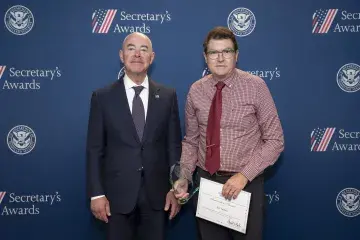 DHS Secretary Alejandro Mayorkas (left) with Innovation Award recipient Jon Turban (right).