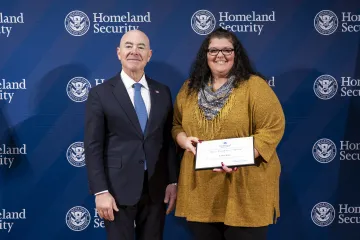 DHS Secretary Alejandro Mayorkas with Team Excellence Award recipient, Laura King.