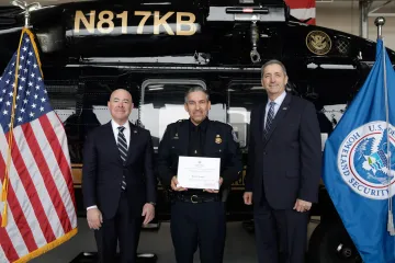 DHS Secretary Alejandro Mayorkas (left) with Innovation Award recipient, Roberto Venegas (center), and DHS leadership (right).