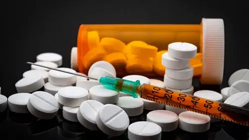 Opioids - pills and syringe