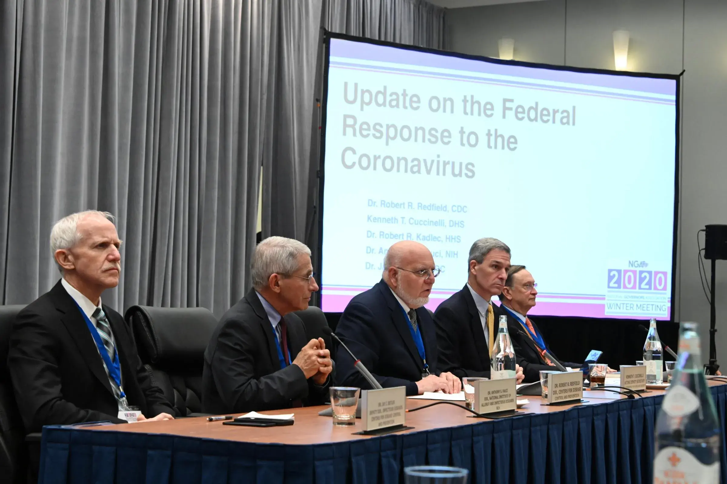 Members of the Coronavirus Task Force and a presentation labeled "Update on the Federal Response to the Coronavirus"