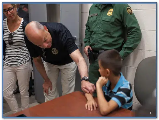 Secretary Johnson speaking to a young child.