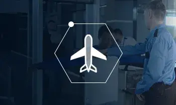 Icon of an airplane in a honeycomb shape over a blue screened photo of person working at an airport. 