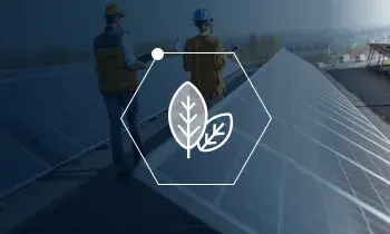 Icon of two leaves in a honeycomb shape over a blue screened photo of people working with solar panels. 