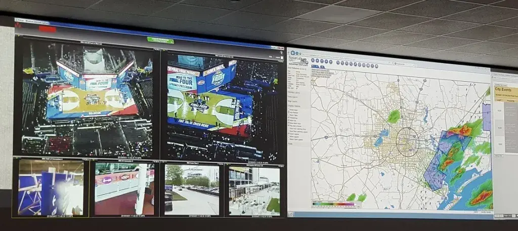 A screen divided into smaller screens displaying different inside and outside areas of a sports arena on the left and a map on the right.
