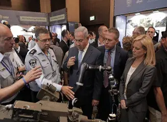 During a visit to Israel in 2018, DHS leadership observes a demonstration of the accessory arm robot next to Israel’s Minister of Public Security Gilad Erdan and Prime Minister Benjamin Netanyahu.