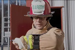 Firefighter uses DAISI automated speech recognition technology for hands-free on-scene report logging and transcription to text.