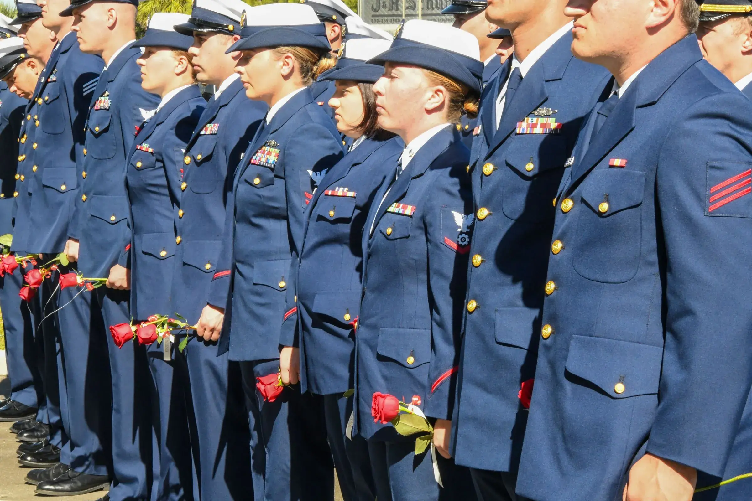 Members of the Coast Guard With Roses