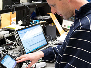 A photo of a man using a computer